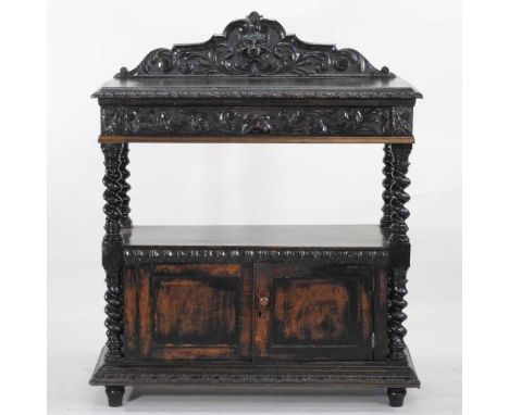 A 19th century continental carved oak buffet, with Green Man decoration, on spirally turned supports107w x 46d x 127h cm