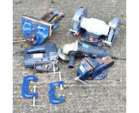 An electric bench grinder, together with a vice and various tools