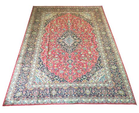 EXTREMELY FINE KASHAN CARPET, 318cm x 255cm, pendant medallion on a ruby field of palmettes and scrolling vines within corres