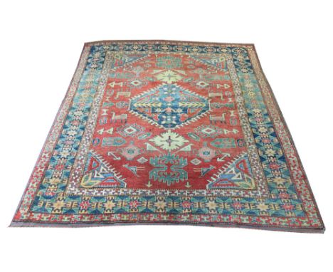 VINTAGE KAZAK RUG, 216cm x 179cm, central medallion on an abrashed terracotta field of stylised motifs within corresponding b