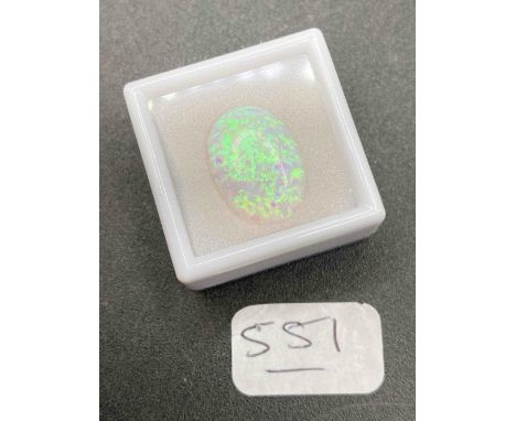 A fine opal stone of 10 carats with fiery blue and green flashes