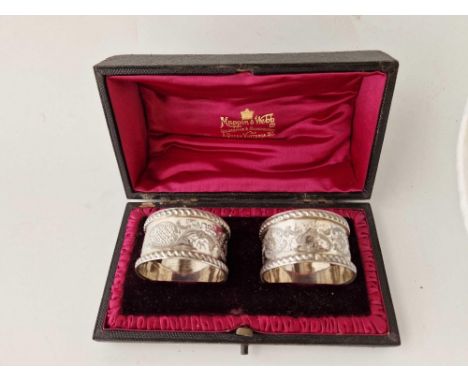 An attractive pair of napkin rings, crisply engraved with scrolls, London 1901 by M&amp;W