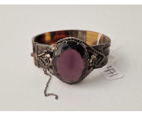 A antique tortoise shell and silver bangle