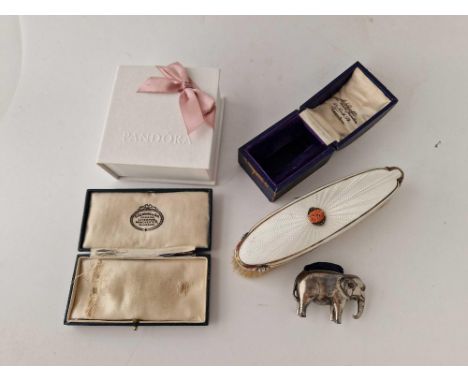 A napkin ring box, two others and enamel and coral clothes brush and an elephant pin cushion