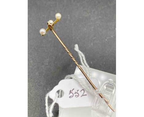 A Victorian diamond and pearl three stone stick pin with screw top in high carat