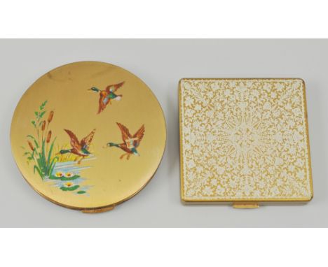 Gilt metal circular compact, decorated with Mallard rising, diameter 7.5cm and another compact, (2).