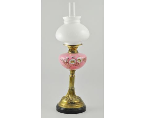 Victorian oil lamp, brass column and base, pink opaque glass reservoir with painted floral decoration, opaque shade complete 