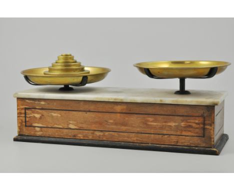 Set of platform scales, with a marble top, complete with brass pans and graduating weights, width 42cm.