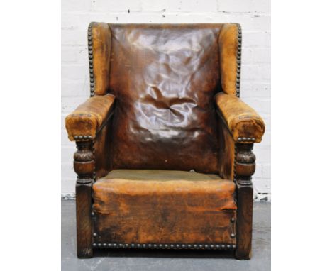 Traditional brown leather close studded deep easy chair, lacking seat cushion, oak framed, width 76cm.