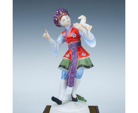 Bone china figure of a lady in a light blue tunic top, red wrapped floral vest and purple hat, holding a mini horse. Part of 