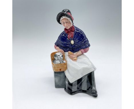 Hand decorated and hand made porcelain figure of a seated woman admiring her puppy companion. Pink, purple, white, gray, and 