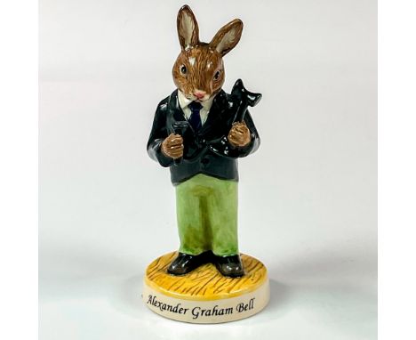 A glossy porcelain figure of a bunny Alexander Graham Bell in a black suit jacket and green pants holding a telephone. Royal 
