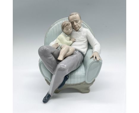 Glossy figure of a grandfather and grandson napping in plush blue armchair. Nao backstamp. Artist: Rafael LozanoIssued: 2000D