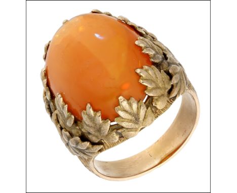 A fire opal dress ring, circa 1960, set with an oval cabochon-cut fire opal, the claws formed as realistically modelled leave