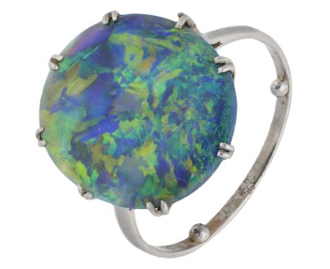 A black opal ring, the shallow cabochon opal displaying a play of greens, blues and purples, in twin claw mount, white precio