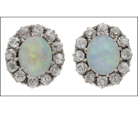 A pair of opal and diamond cluster ear studs, each with central oval cabochon opal, within a surround of 12 old brilliant-cut