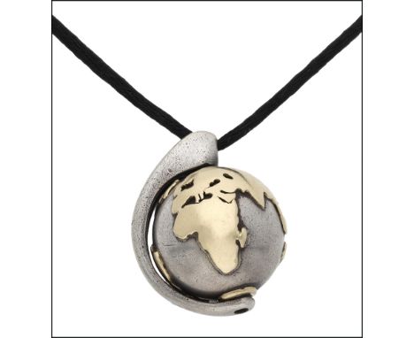 An Earth and Moon pendant necklace by Minas, the bi-coloured globe rotating on an axis, suspended from a black cord with a fu