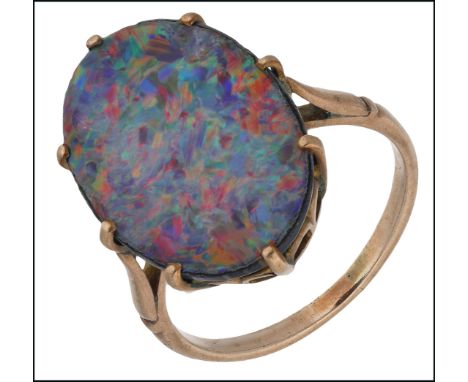 An opal doublet ring, the opal doublet within an eight-claw setting, between tapered shoulders, ring size L. £300-£500