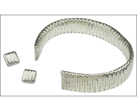 A silver herringbone weave choker necklace and earclips by Angela Cummings, the broad torque sprung necklace of flexible form