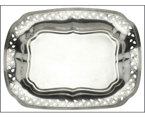 A silver shaped oval dish by Tiffany &amp; Co, with pierced meandering foliate border and reeded edge, raised on flattened bu
