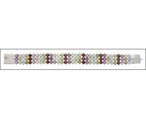 A silver and gem-set bracelet, composed of triple rows including citrine, amethyst, garnet, peridot etc, with beaded edge, to
