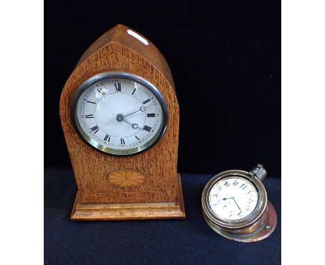 AN EARLY 20th CENTURY MOTOR CAR CLOCKbeing a goliath watch fitted into a brass case, with sloped back for dashboard fixing, m