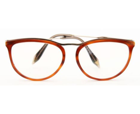 Damenbrille, Victoria Beckham. Vollrandmodell aus goldfarbenem Metall und goldbraunem Kunststoff. L. Tragespuren. Modell-Nr. 