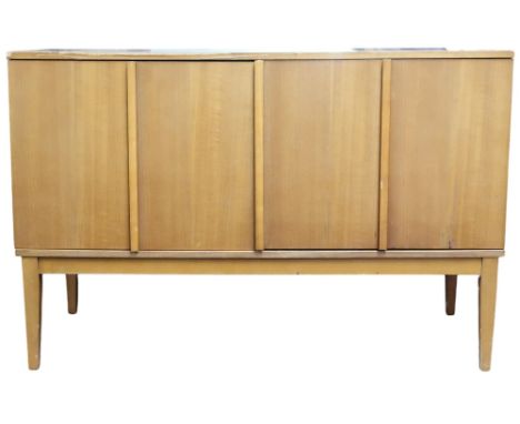 A mid 20th century teak record cabinet with pair of concertina doors on tapering supports, 61cm high x 92cm wide x 39cm deep 