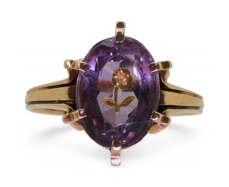 A yellow metal mourning ring, set with an amethyst inlaid with a gold forget-me-not set with a rose cut diamond, finger size 