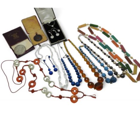 A Chinese carnelian and green hardstone necklace linked with fancy knotwork, a string of lapis lazuli beads, amber coloured g