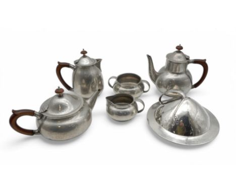 A Tudric pewter muffin lid, unmarked, together with a Liberty and Co English Pewter five piece tea set with hammered decorati