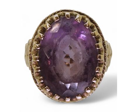 A 9ct gold amethyst ring with a scroll mount, size M, weight 6.2gms Condition Report:Available upon request