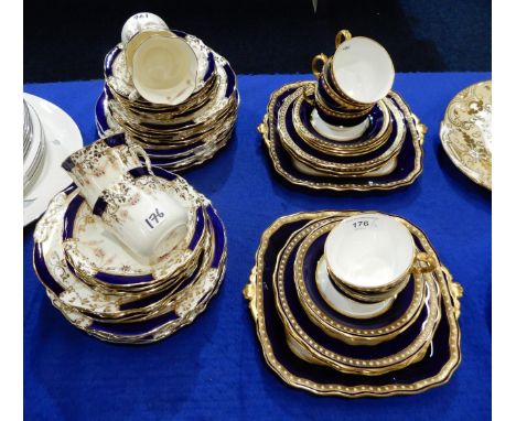A Royal Crown Derby tea set, the white ground with blue border with gilt band decorated with white dot detail, comprising fiv