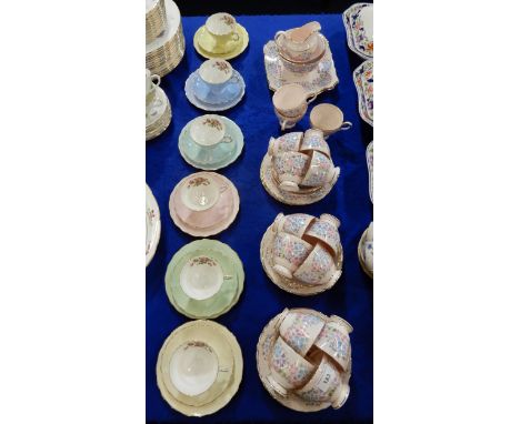 A Plant Tuscan tea set the pale pink ground with blue, lilac and pink flowers, comprising 15 cups, 12 saucers and plates, two