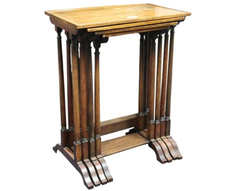 An early 20th century walnut veneered Georgian style nest of four tables with tapering turned supports on sledge supports, 61