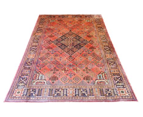 FINE MEY-MEY CARPET, 270cm x 173cm, diamond medallion on a terracotta field of stylised floral amulets, within complimentary 