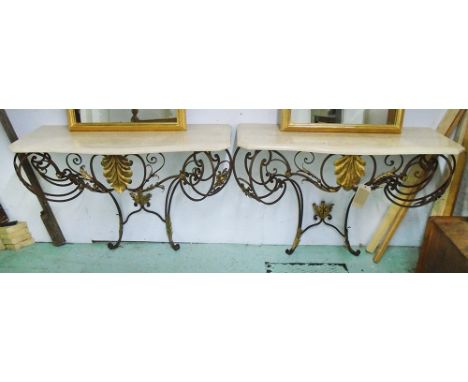 CONSOLE TABLES, a pair, 20th century wrought iron and gilded with serpentine travertine marble tops on leaf scroll supports, 