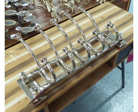 WALL COAT HANGERS, contemporary style, painted metal with wall hanging inserts, 27cm H x 59cm W.
