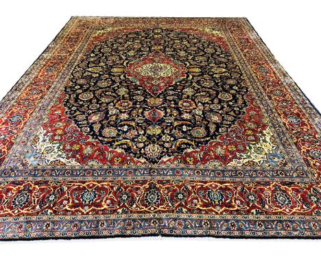 VERY FINE SIGNED KASHAN CARPET 445cm x 325cm, central medallion on a midnight blue field of palmettes and scrolling vines wit