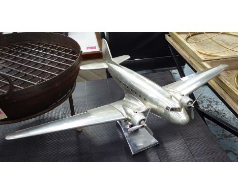 MODEL AIRCRAFT, in aluminium finish on stand, 66cm x 98cm x 35cm H. 