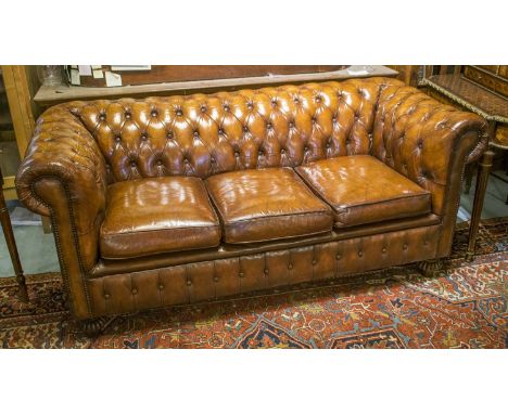 CHESTERFIELD SOFA, vintage hand finished brown leather with rounded button upholstered back and arms, with turned supports, 1