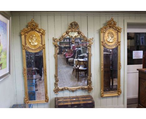 Pair rectangular gilt framed bevelled wall mirrors with relief portrait panels, 178cm by 51cm overall.
