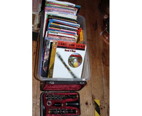 Cased Yamaha clarinet and collection of music books.