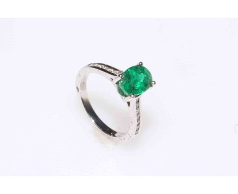 Emerald and diamond ring set in 18 carat white gold having 1.70 carat oval emerald, size K.