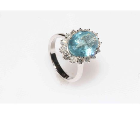 18 carat white gold, aquamarine and diamond cluster ring, having 4 carat oval aqua bordered with 1.22 carat of brilliant cut 