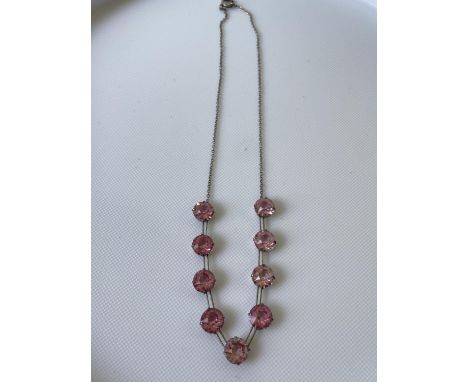 A vintage white metal art deco necklace fitted with 9 large pink cut stones [length 35cm] 