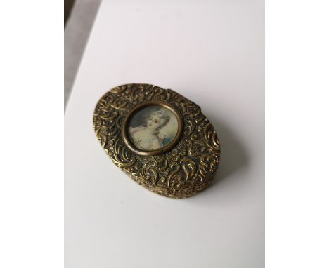 A 19th century gilt metal snuff box of oval form. Designed with a miniature lady portrait to the lid. [2.2x6.5x4.5cm] 