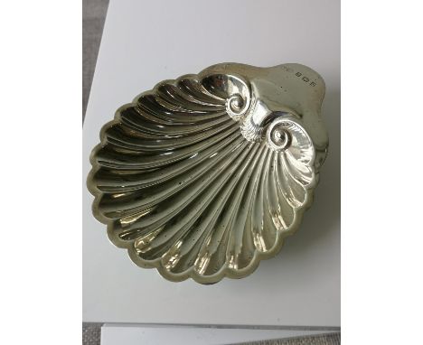 A Birmingham silver Scallop shaped pin dish sat upon three bun supports. Maker W. G. K. [59.62GRAMS] [2.5X13X10.5CM] 