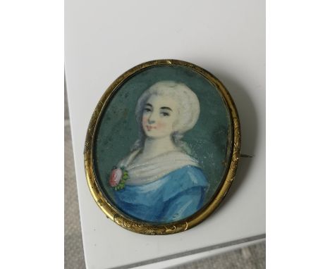 A 19th century miniature lady portrait within a gilt metal surround brooch. [6x5.1cm] 