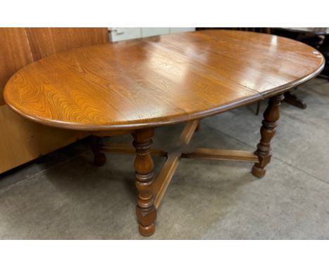 An Ercol Golden Dawn ash extending dining table 